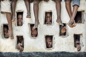 THIS IMAGE MUST NOT BE PUBLISHED DIGITALLY IN THE PUBLIC DOMAIN. Image COPYRIGHT - Timothy Allen - http://humanplanet.com - You may NOT reproduce this image in any media format without written consent. Please contact http://humanplanet.com for syndication options. Sent to sipacontest.com. Italy. CAPTION: Inquisitive children watch a film crew at work in River Gee, Liberia